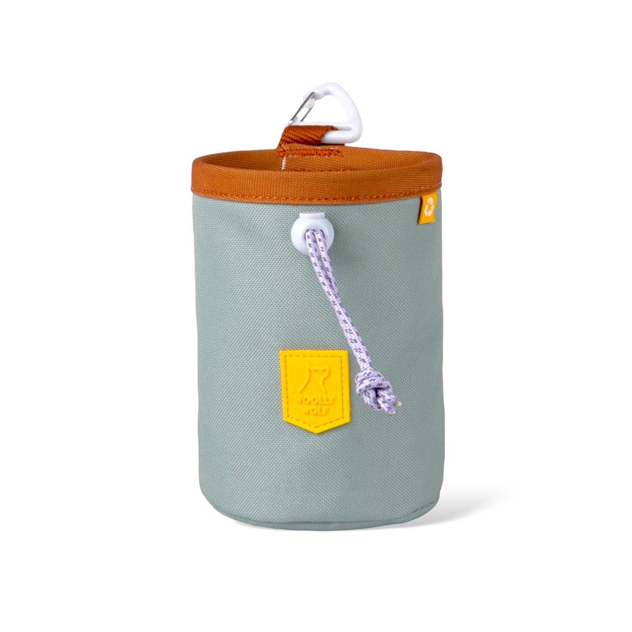 The Alpha 360 Dog Snack Bag Glacier Green is a cylindrical, light gray fabric pouch with a brown rim, yellow patch, white cord, and a white carabiner clip at the top.