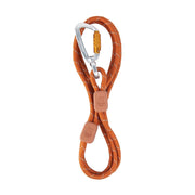 The Rope Dog Leash Thin Terracotta is an orange leash with reflective stitching, two brown rubber stoppers, and a silver locking carabiner on one end.