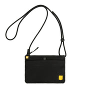 Black crossbody pouch with yellow accents and an adjustable strap, displayed on a white background.