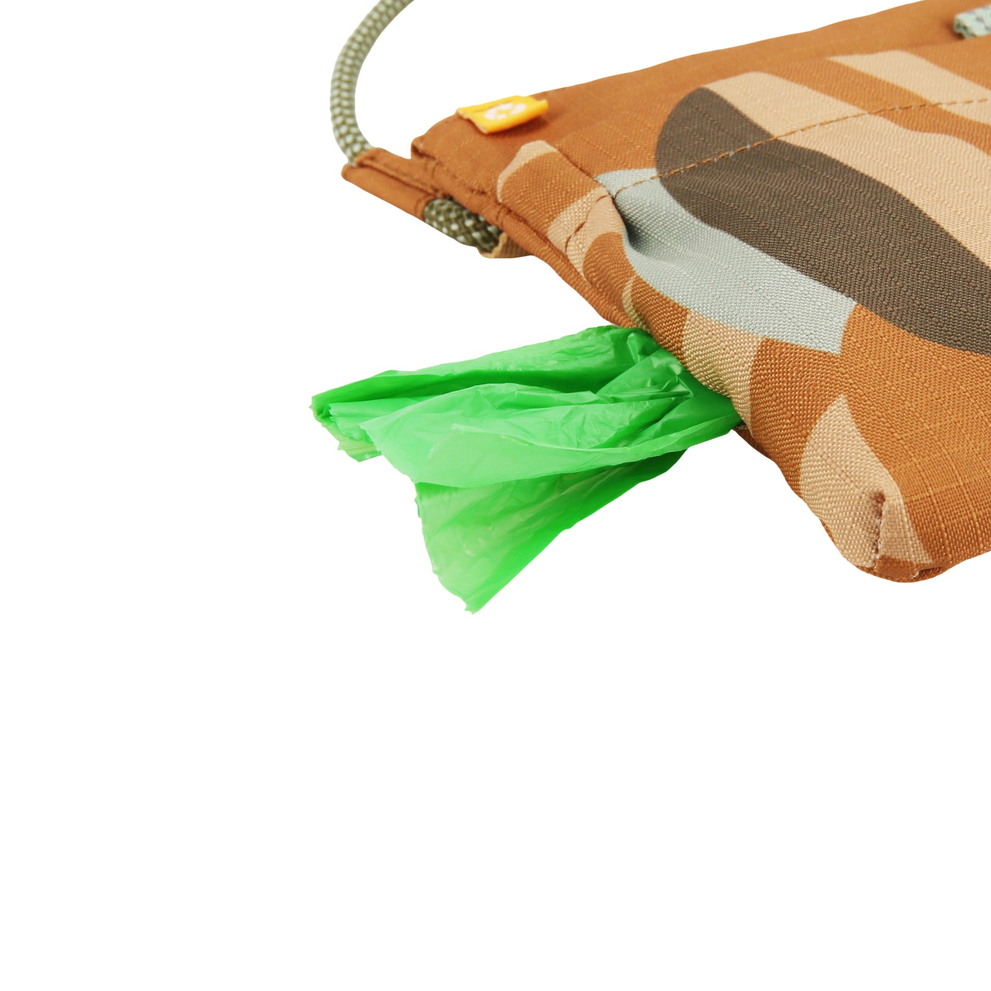 Green plastic bags sticking out of a patterned brown fabric pouch with a drawstring.