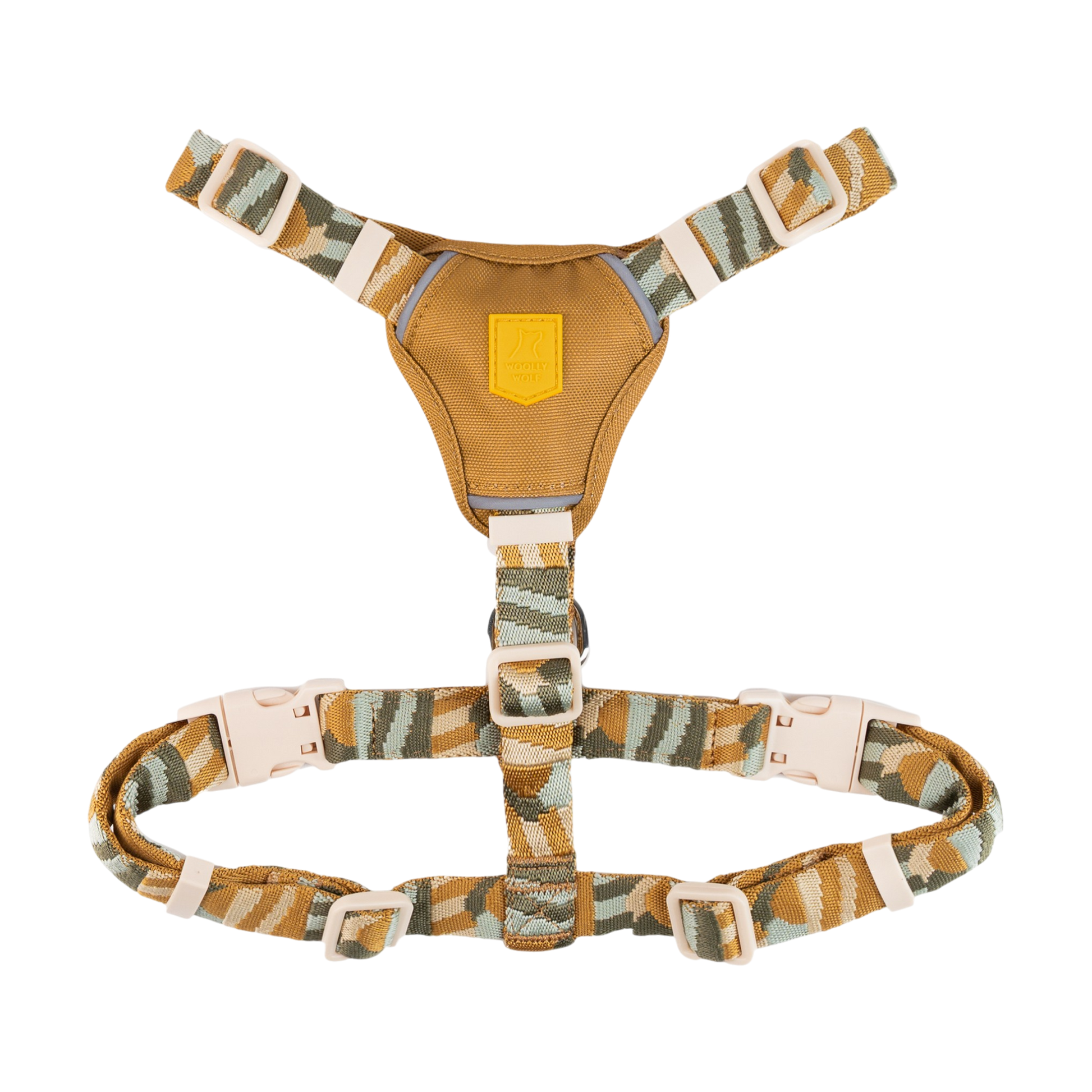 A camouflage-patterned dog harness with adjustable straps and plastic buckles on a white background.