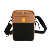 Small brown and black crossbody bag with adjustable strap and front pocket against a white background.