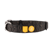 Black patterned dog collar with two yellow labels featuring the Woolly Wolf logo and a recycled icon.