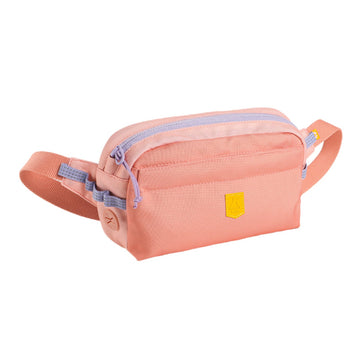 The Alpha 360 Hip Pack Salmon Pink features a peach-colored design with a front zip pocket, lavender zipper, matching adjustable strap, and a small yellow patch on the front.